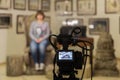 TV shooting at the Museum. LCD monitor on the camcorder. The girl in front of the camera. A record of the interview Royalty Free Stock Photo