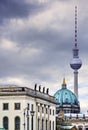 TV tower, Berlin cathedral and historical German museum one behind the other in front of a gray sky with a lot of negative space