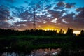 TV tower at sunset near the forest and lake Royalty Free Stock Photo