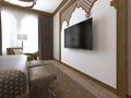 A TV on the wall and a TV stand, wooden carvings framed in Middle Eastern Arabic style