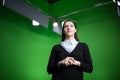 TV weather news reporter at work.News anchor presenting the world weather report.Television presenter recording in a green screen