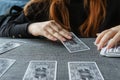 TVER, RUSSIA - FEBRUARY 11, 2023. Tarot cards, Tarot card divination, esoteric background. A woman makes a layout on the