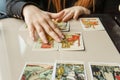 TVER, RUSSIA - FEBRUARY 11, 2023. Tarot cards, Tarot card divination, esoteric background. A woman makes a layout on the