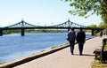 TVER, Russia, May 2021: Afanasy Nikitin Embankment view of the Starovolzhsky Bridge. A couple of tourists on the Afanasy Nikitin Royalty Free Stock Photo