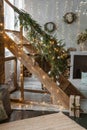 Tver, Russia-November 10, 2021. Home New Year's interior. A live Christmas tree and a wooden staircase in the kitchen