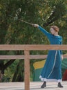 A girl in a long dress demonstrates her sword skills Royalty Free Stock Photo