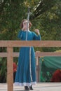 A girl in a long dress demonstrates her sword skills Royalty Free Stock Photo