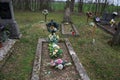 TVRDOMESTICE, SLOVAKIA - 12.3.2016: Graves, tombstones and crucifixes on traditional cemetery. Votive candles lantern and flowers