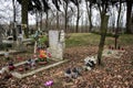 TVRDOMESTICE, SLOVAKIA - 12.3.2016: Graves, tombstones and crucifixes on traditional cemetery. Votive candles lantern and flowers