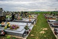 TVRDOMESTICE, SLOVAKIA - 12.3.2016: Graves, tombstones and crucifixes on traditional cemetery. Votive candles lantern and flowers