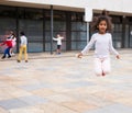 Tween African American girl skipping rope in schoolyard Royalty Free Stock Photo