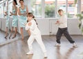 Tween girl and boy rehearsing popping techniques in street dance studio Royalty Free Stock Photo