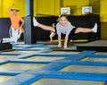 Tween girl doing split in jump in indoor trampoline arena Royalty Free Stock Photo