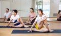 Tween girl doing twisting asana Matsyendrasana during family yoga class Royalty Free Stock Photo