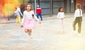 Tween girl in pink skirt jumping rope in schoolyard during recess Royalty Free Stock Photo