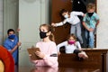 Tween girl in protective mask reading task in quest room Royalty Free Stock Photo