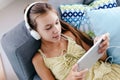 Tween girl relaxing on couch at home Royalty Free Stock Photo