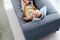 Tween girl relaxing on couch at home Royalty Free Stock Photo