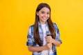 tween girl singer perform karaoke isolated on yellow background. With microphone in hand teenage girl singer. young