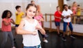 Tween girl training vigorous dance during group class