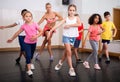 Tween girl training vigorous dance during group class