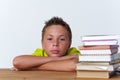 Tween pensive child sitting at table with books Royalty Free Stock Photo