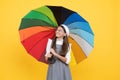 tween with vivid rain protection. happy school girl in glasses. teen child under colorful parasol Royalty Free Stock Photo