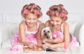 Tweenie girls in hair curlers with dog