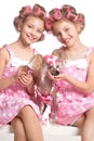 Tweenie girls in hair curlers with dog