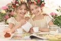 Tweenie girls in wreaths with magazine Royalty Free Stock Photo