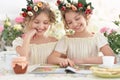 Tweenie girls in wreaths with magazine Royalty Free Stock Photo