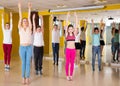Tweens exercising with coach in choreography class