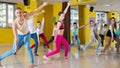Tweens exercising with coach in choreography class