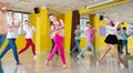 Tweens exercising with coach in choreography class