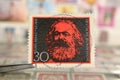 Tweezer holds postage stamp of Germany 150th Birth Anniversary of Karl Marx