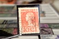 Tweezer holds postage stamp Queen Wilhelmina Reign jubilee
