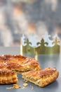 Epiphany Twelfth Night cake french galette des rois made of puff pastry, slice apart with the charm inside, open crown