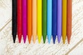 Twelve color pastel crayon in box close up with woody texture backgrou Royalty Free Stock Photo
