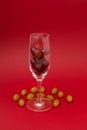 Twelve grapes in glass for sparkling wine cava. Spanish traditional to eat twelve 12 berries for good luck at midnight. Christmas Royalty Free Stock Photo