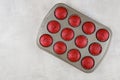 Twelve red velvet cupcakes in baking pan on white background Royalty Free Stock Photo