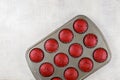 Twelve red velvet cupcakes in baking pan on white background Royalty Free Stock Photo