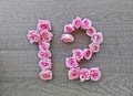 12, twelve - vintage number of pink roses on the background of dark wood