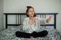 Twelve year old cute girl having fun in her room sitting on bed