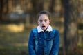 Twelve-year-old girl posing in a summer pine Park