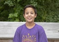 Twelve yearold Amerasian boy posing on wooden bridge in Washington Park Arboretum, Seattle, Washington