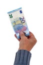 Twenty euro banknote held in hand close up on white background