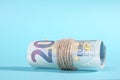 The Twenty Euro notes rolled over a blue background Royalty Free Stock Photo