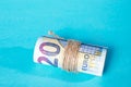 The Twenty Euro notes rolled over a blue background Royalty Free Stock Photo