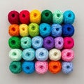 Twenty five balls of yarn are arranged in a 5x5 grid on a plain background Royalty Free Stock Photo