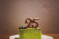 Twenty five years anniversary. Birthday chocolate cake with white burning candles in the form of number Twenty five Royalty Free Stock Photo